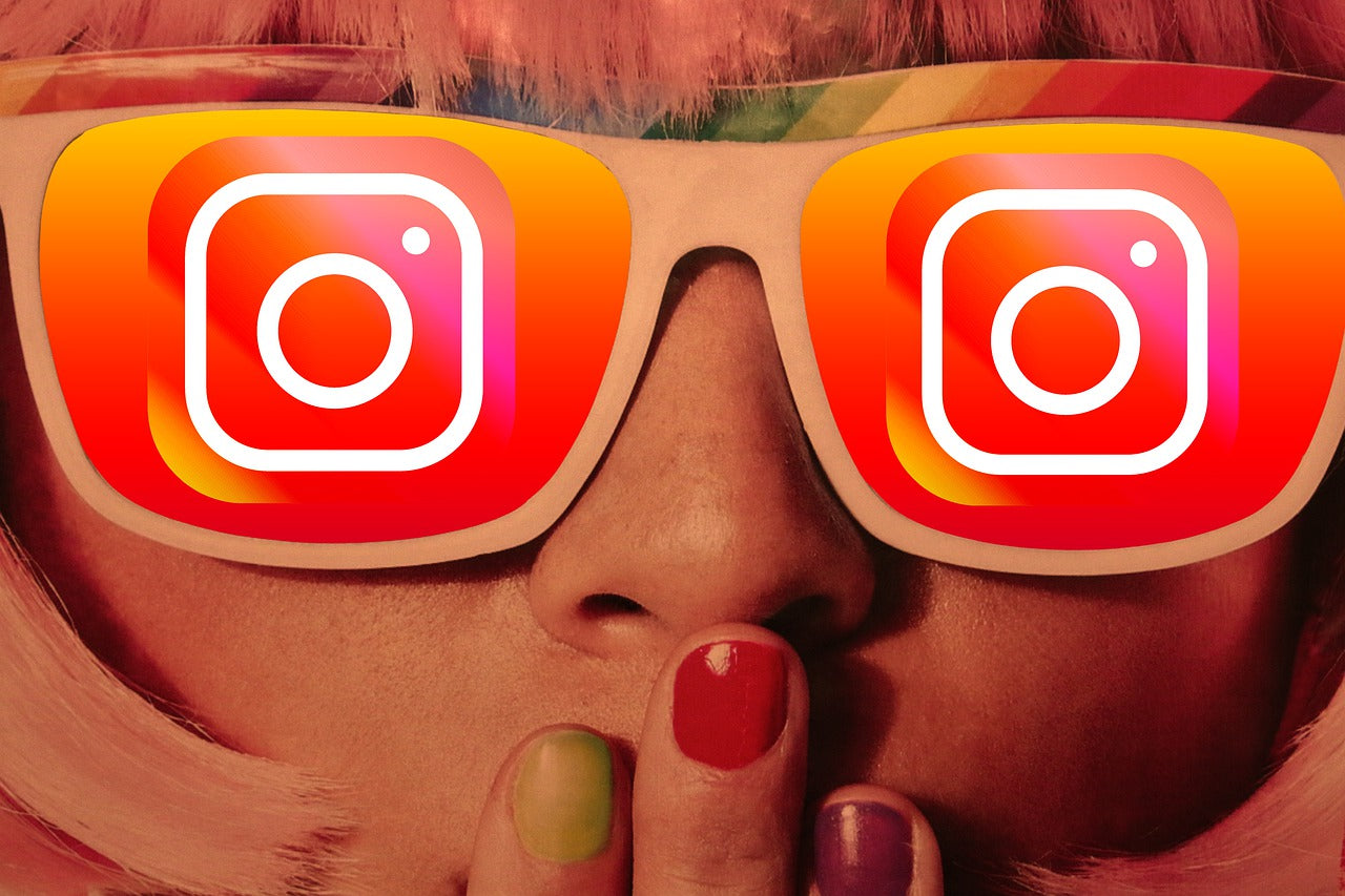  Close-up of a girl wearing sunglasses with the Instagram logo on the lenses