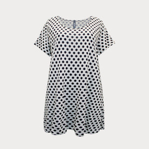 Black and white short sleeved spotty top with round neckline, cut to a longer length. 