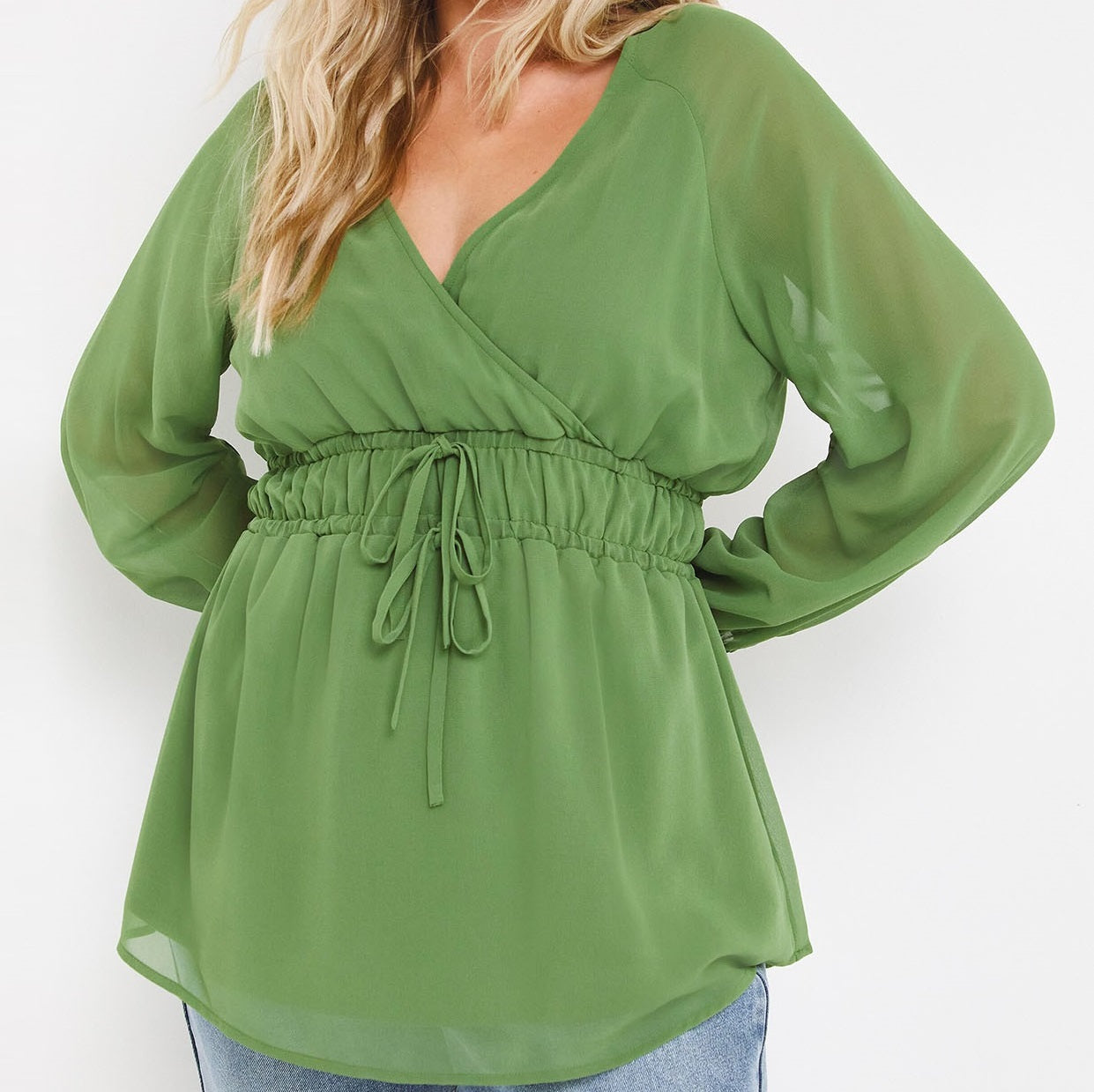Forest green blouse with shirred waist and a deep v-neckline.