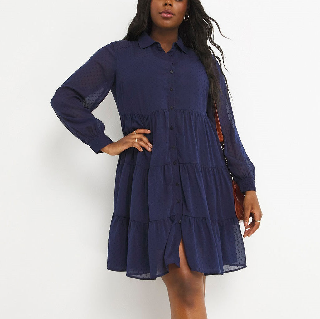 Navy shirt dress with its tiered skirt, button front and sheer sleeves