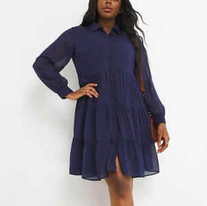 Navy shirt dress with its tiered skirt, button front and sheer sleeves