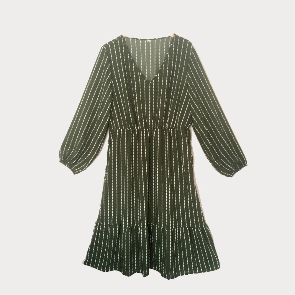 Sage green plus size midi dress with white stripe to the fabric and a cinched waist. 